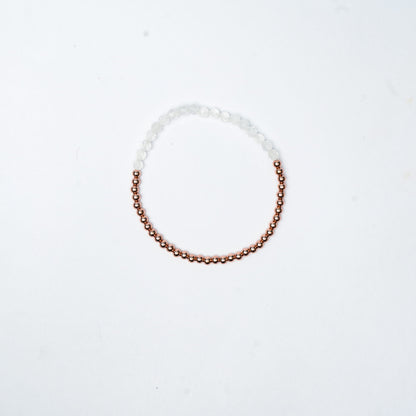 Stretch Bracelet with Clear Quartz beads, 3mm copper beads and elastic wire on a white 