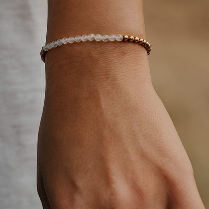 Clear quartz faceted beaded bracelet on a wrist with a natural background